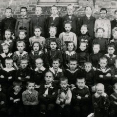 SA Schleiden, Bildsammlung: Lehrer Küpper mit Schulkindern des 4. bis 8. Schuljahres vor der Broicher Volksschule, 1922.